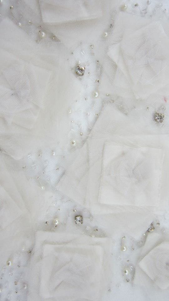 Manipulation of Hand cut fabrics with Japanese pearls, rhinestones and glass beads on tulle